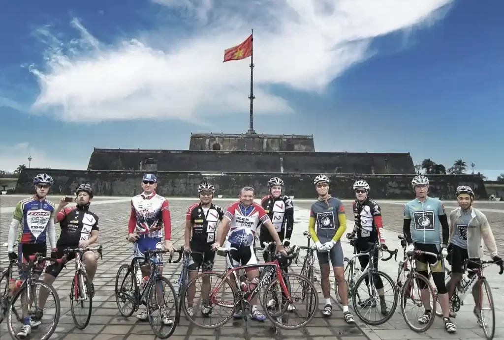 Cycling group in front of main tower in the citadel of Hue, Vietnam